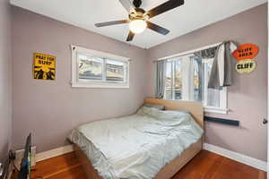 Bedroom featuring ceiling fan and dark wood-type flooring