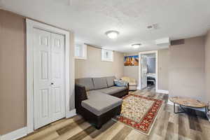 Living room featuring hardwood / wood-style flooring and a textured ceiling