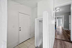 Hall featuring light tile patterned flooring