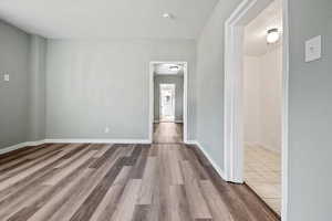 Empty room with light hardwood / wood-style flooring