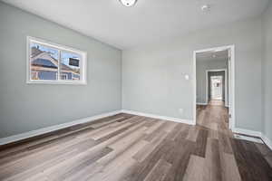 Unfurnished room with hardwood / wood-style floors