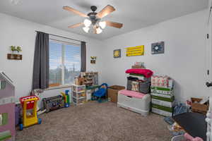 Game room with carpet and ceiling fan