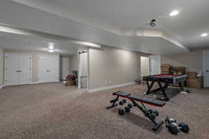 Interior space with carpet flooring and a textured ceiling