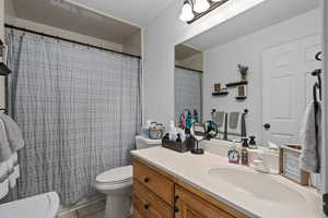 Bathroom with tile patterned floors, vanity, and toilet