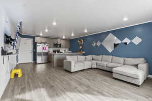 Living room with sink and light wood-type flooring