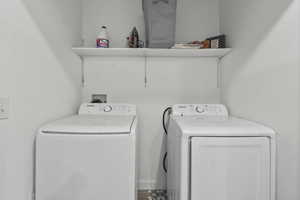 Laundry area featuring washing machine and clothes dryer