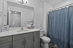 Full bathroom featuring vanity, toilet, wood-type flooring, and shower / bath combo