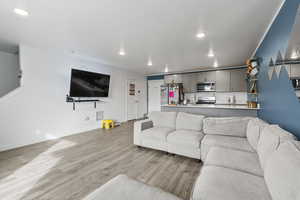 Living room with light hardwood / wood-style flooring