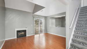 Unfurnished living room featuring wood-type flooring