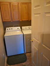 Laundry area featuring cabinets and independent washer and dryer