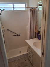 Bathroom featuring vanity and curtained shower