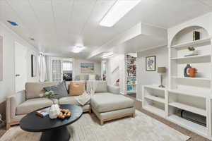 Carpeted living room featuring crown molding