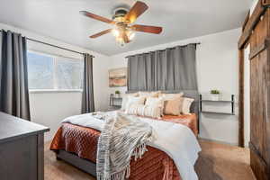 Carpeted bedroom featuring ceiling fan