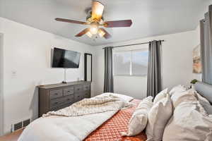 Carpeted bedroom with ceiling fan