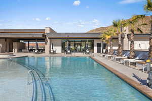 View of pool with a mountain view and a patio