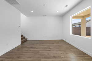 Spare room featuring dark wood-type flooring