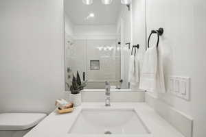 Bathroom with vanity, toilet, and an enclosed shower