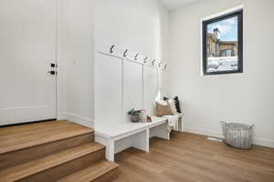 Mudroom with light hardwood / wood-style floors