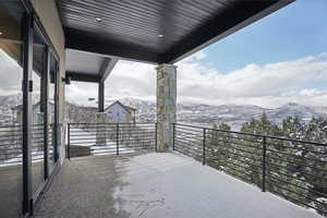 Snow covered back of property featuring a mountain view