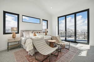 Carpeted bedroom with access to outside and lofted ceiling