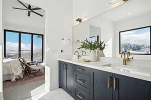 Bathroom featuring a mountain view, vanity, and ceiling fan