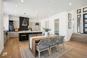 Dining area with light hardwood / wood-style flooring and sink