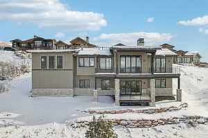 Snow covered property featuring a balcony