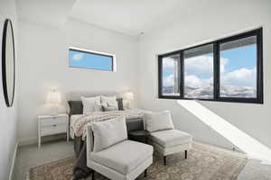 Carpeted bedroom with refrigerator