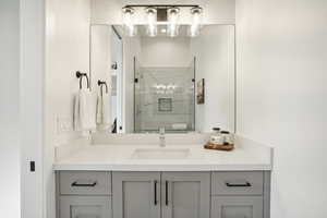 Bathroom featuring vanity and an enclosed shower