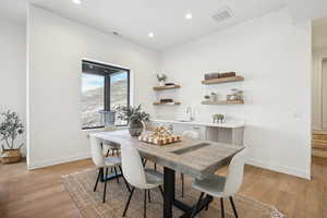 Dining space with light wood-type flooring and sink