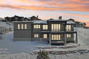 Snow covered house with a balcony