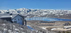 Property view of mountains with a water view