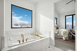 Bathroom featuring a mountain view and a relaxing tiled tub