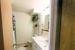 Bathroom featuring tile patterned floors, vanity, and toilet