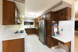 Kitchen with dark brown cabinetry