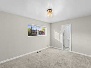 Carpeted spare room featuring a textured ceiling