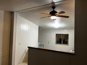 Kitchen featuring ceiling fan and a textured ceiling