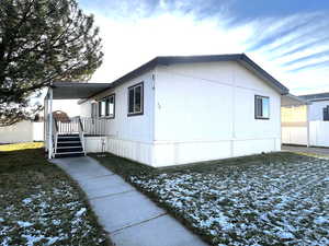 View of home's exterior with a yard