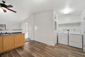 Washroom featuring ceiling fan, dark hardwood / wood-style flooring, sink, and washing machine and clothes dryer