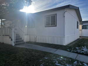 View of side of home with a lawn