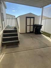 View of patio / terrace featuring a storage shed