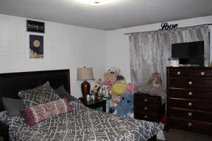 Duplex # B Bedroom with carpet floors and a textured ceiling