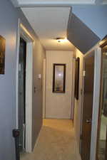 Duplex # A Hallway featuring a textured ceiling