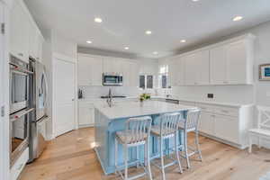 Classic white kitchen with lovely blue island cabinetry