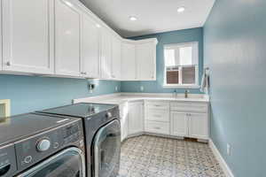 Spacious laundry room with lots of storage and sink