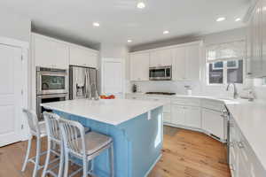 Brand new kitchen with custom white cabinets and quartz countertops