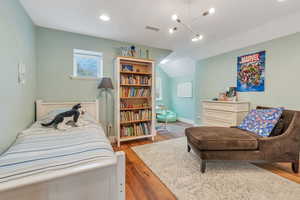 Bedroom #1 upstairs with hardwood flooring and reading nook.