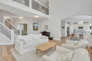 Vaulted great room with build in bookshelves and floor to ceiling windows.