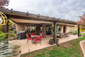 View of patio featuring a grill