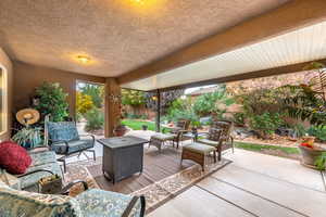 Fenced backyard featuring a patio and outdoor lounge area